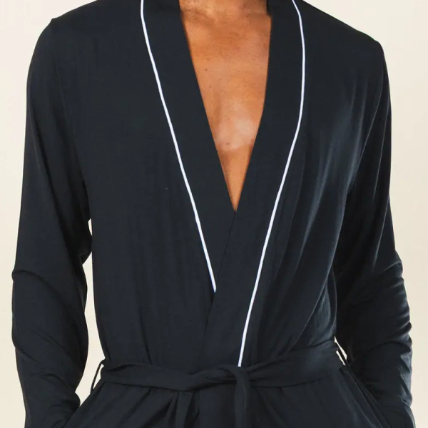 Black Shinesty robe with a white-piped shawl collar, worn open at the chest