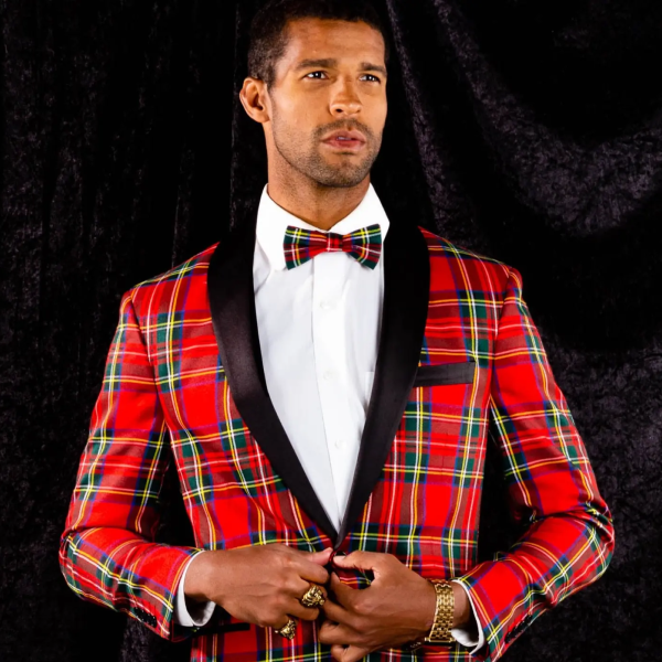 Red tartan Shinesty tuxedo jacket with a black shawl collar and plaid bow tie, being buttoned at the front