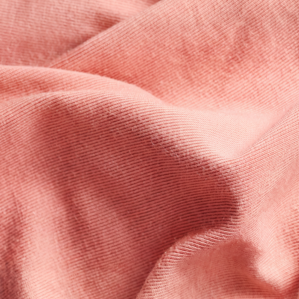 Coral-pink MicroModal fabric in loose, silky folds, the material behind Shinesty women's underwear