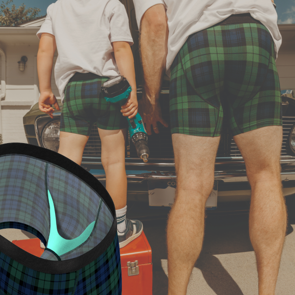 Father and son in matching green plaid boxer briefs working under a car hood, inset of the kid-sized pouch design